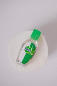 Close-up of a Dettol sanitizer bottle on a white background promoting hygiene and cleanliness.