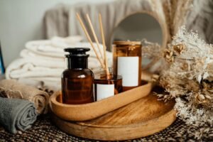 A tranquil spa setup featuring aromatherapy oils, candles, and dried flowers for relaxation.